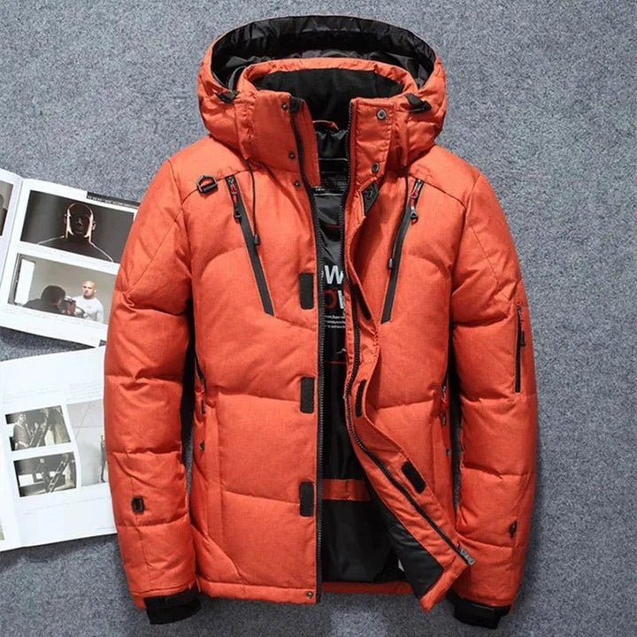 Orange winter jacket with black accents on a gray background