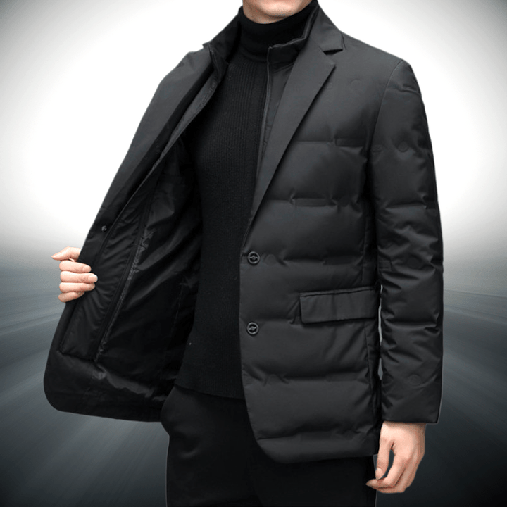 Black puffer coat worn by a person on a gray background